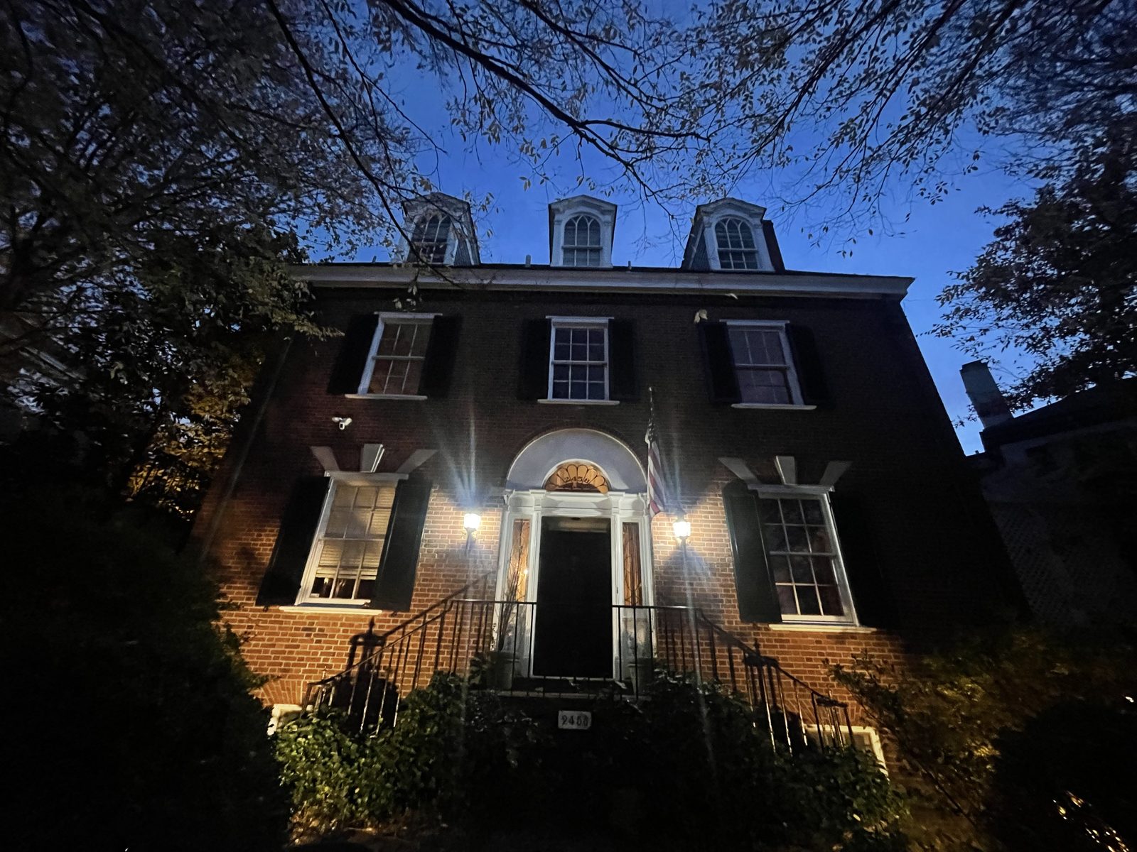 Exterior of a multi-story brick residence at dusk