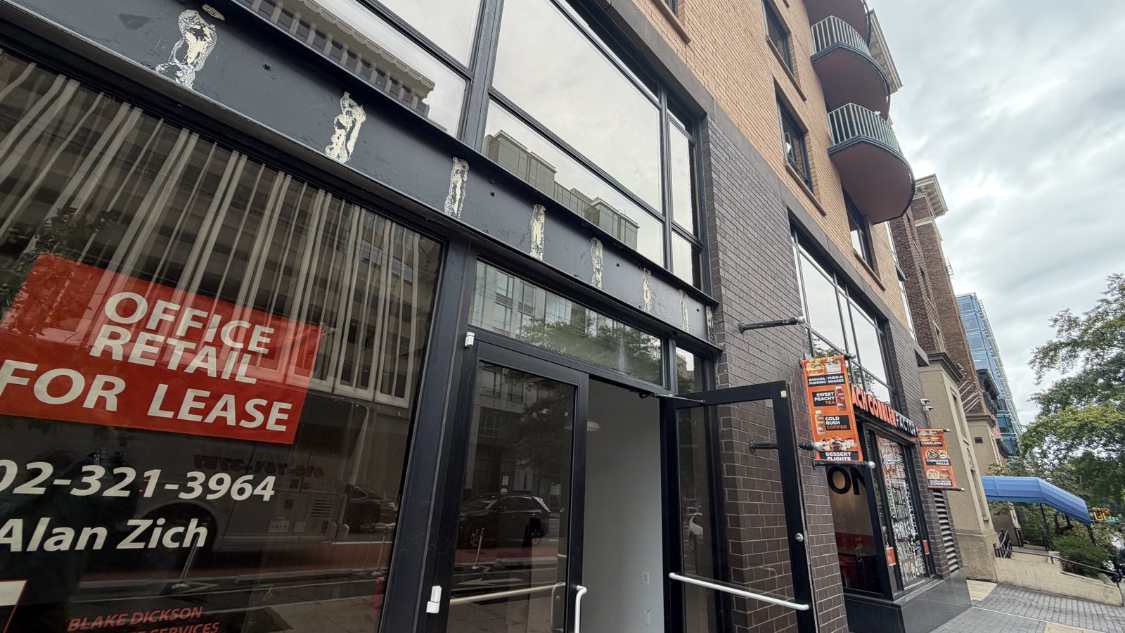 Street-level commercial storefront in a mixed-use brick building